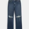 Bardzo wysokie, podarte, ciemnoniebieskie jeansy typu dad jeans