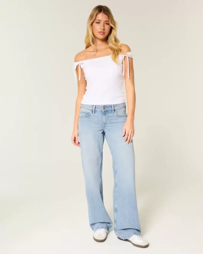 Jeansy Baggy z niskim stanem i lekkim spraniem, z ćwiekami i kokardkami