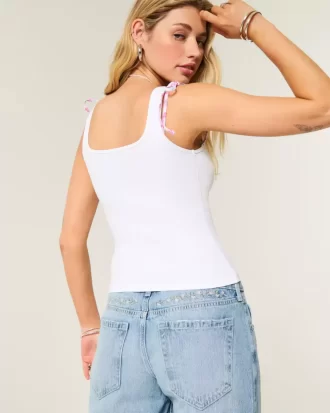 Jeansy Baggy z niskim stanem i średnim spraniem, z kwiatowym haftem Jeansy Baggy z niskim stanem i średnim spraniem, z kwiatowym haftem