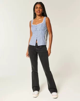 Jeansy Bootcut z niskim stanem i spranymi czarnymi nogawkami Jeansy Bootcut z niskim stanem i spranymi czarnymi nogawkami