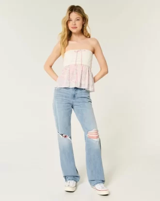 Luźne jeansy z niskim stanem i przetarciami, lekko sprane