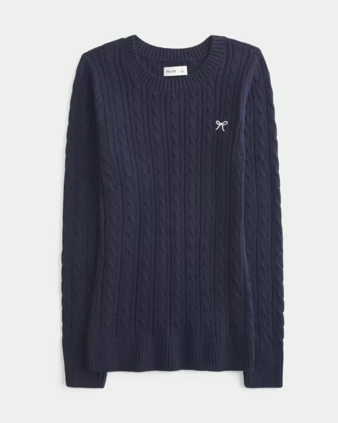 Sweter z okrągłym dekoltem i kokardą w splocie kablowym